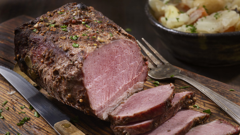 corned beef sliced on cutting board