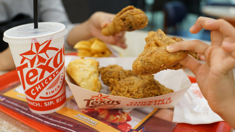 Church's Texas Chicken wing held in hand