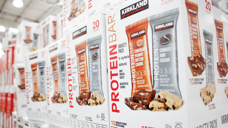 Boxes of Kirkland Signature Protein Bars on display in a Costco store