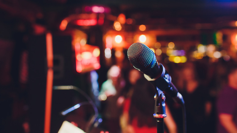 Closeup of a microphone with a blurred restaurant in the background