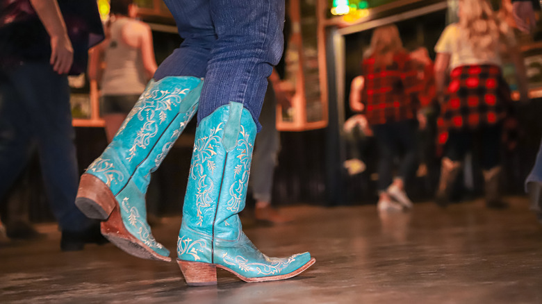 Closeup of turquoise boots in a line dance group