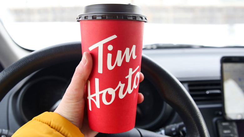 Tim Hortons coffee cup inside of a car