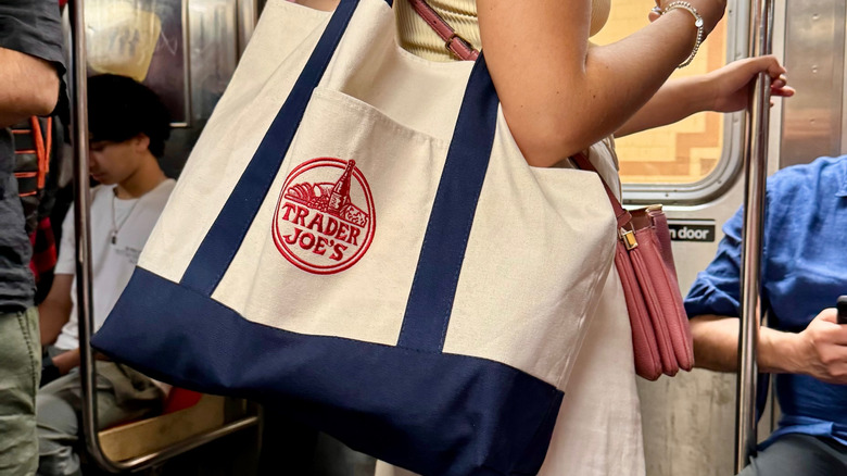 Person with Trader Joe's bag on subway