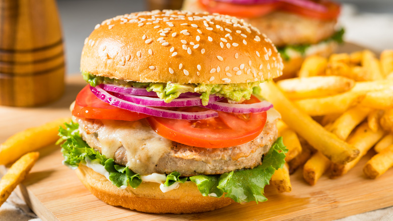 Prepared turkey burger served with fries.