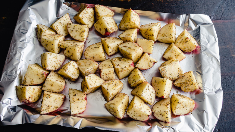 Aluminum foil lined pan with seasoned potatoes