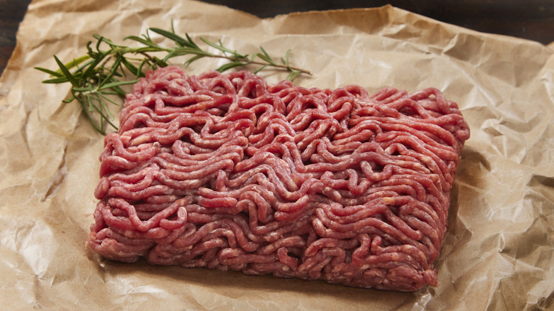 A pound of ground beef rests on butcher paper