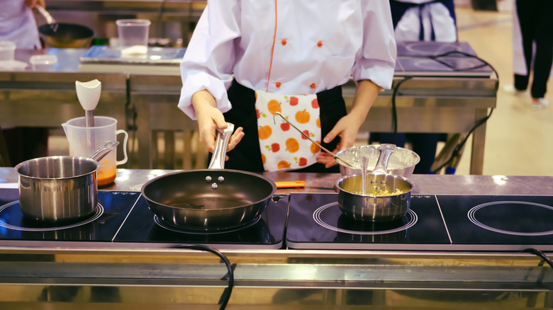 cook preparing food in shared kitchen