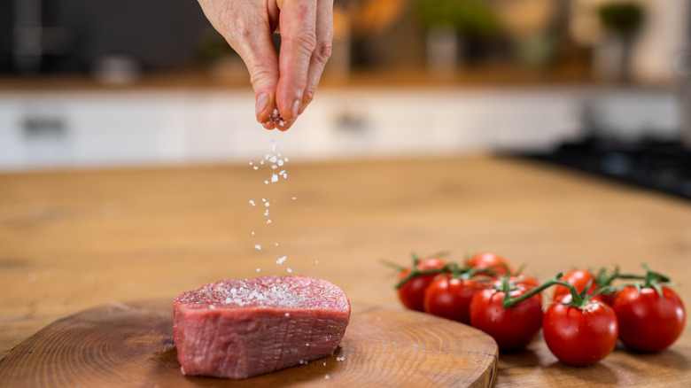 seasoning meat in kitchen