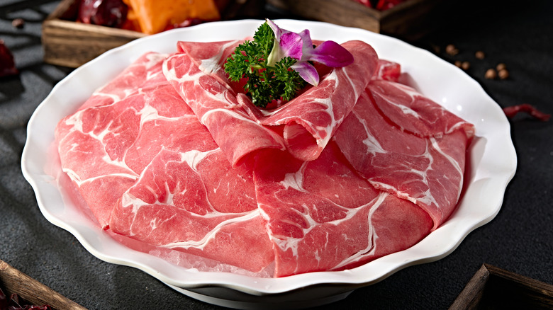 Thin beef roll slices on a plate for shabu shabu