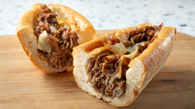 Cheesesteak sandwich on wooden board