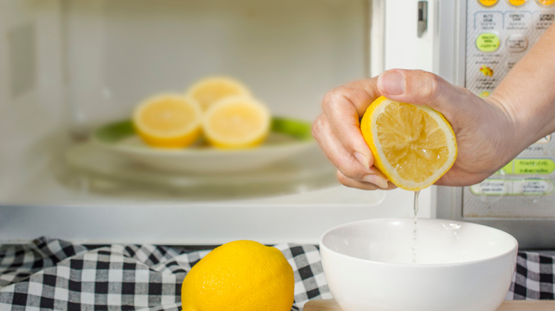 Person juicing lemons from the microwave