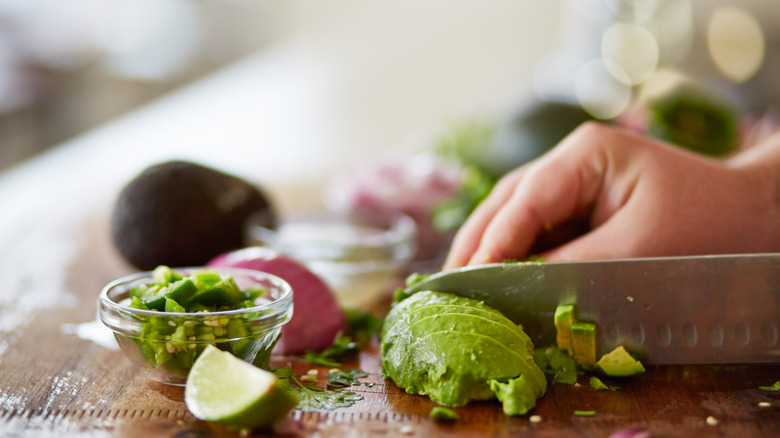 Cutting avocado with knife