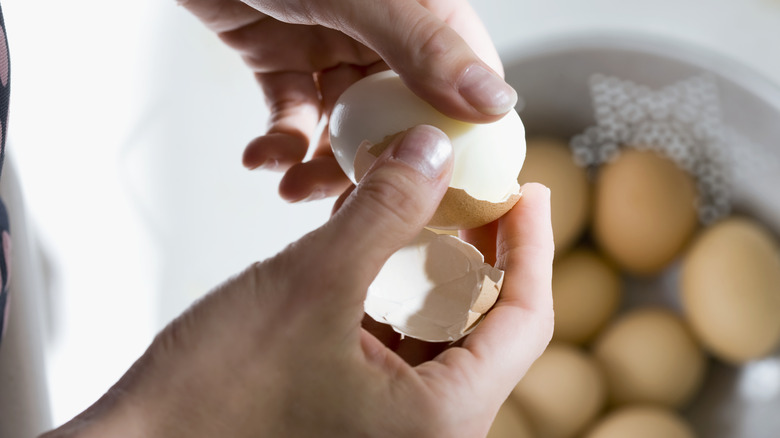 Person peeling egg