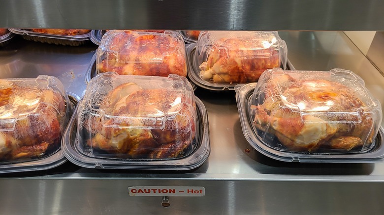 chickens in containers under heat lamp