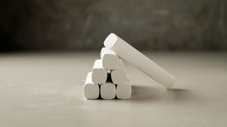 Sticks of white chalk sitting on a table