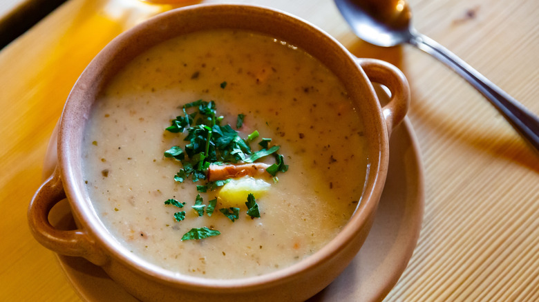 A thick soup with bacon, egg, and potato
