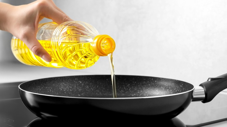 Pouring oil into frying pan