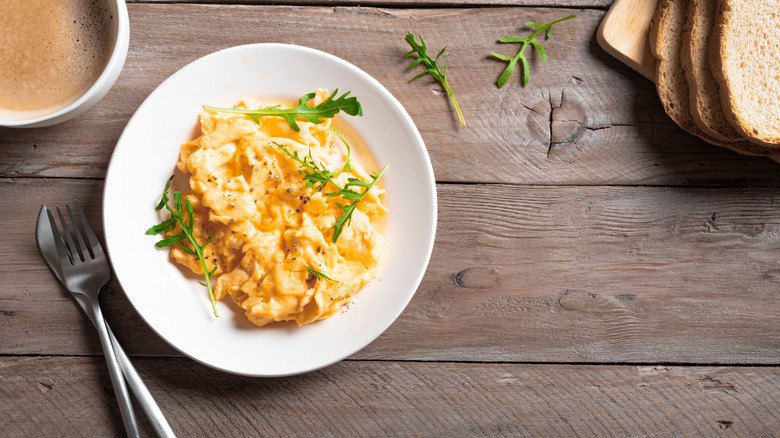 Fluffy scrambled eggs on a white plate