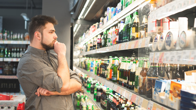 Man looking at beer