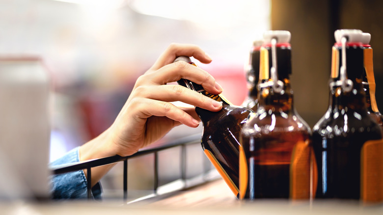 Hand taking beer from shelf