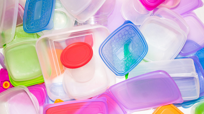 Plastic food storage containers are jumbled together.