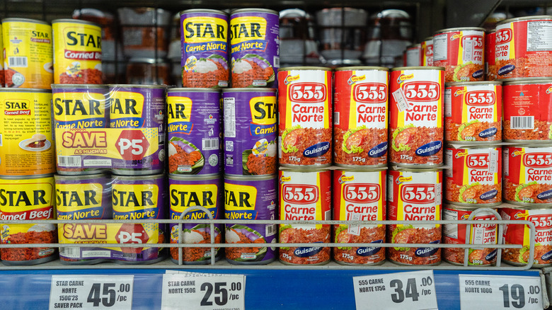 Stacks of canned goods in grocery aisle