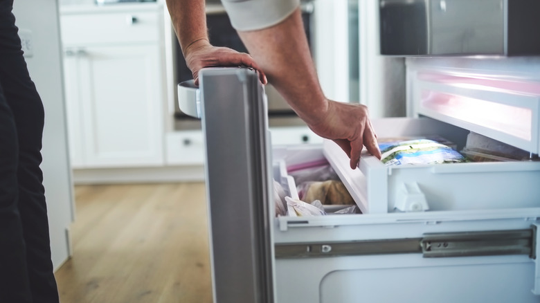 Person opening freezer