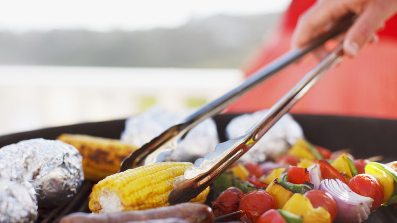 Using tongs to grill