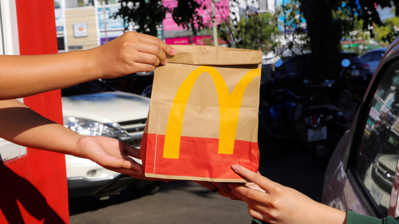 A drive-thru customer receives McDonald's.