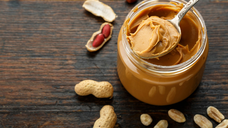 A jar of peanut butter with a spoon