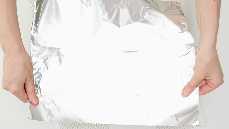 Person holding a piece of foil