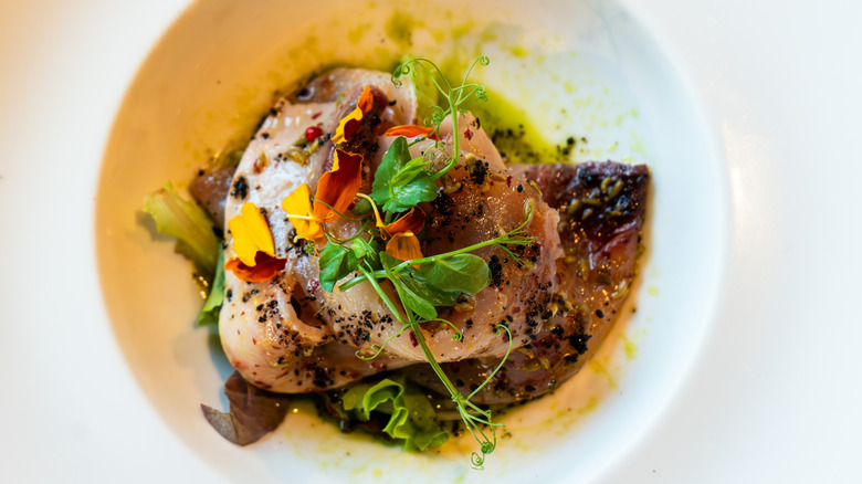 swordfish carpaccio with herb garnish