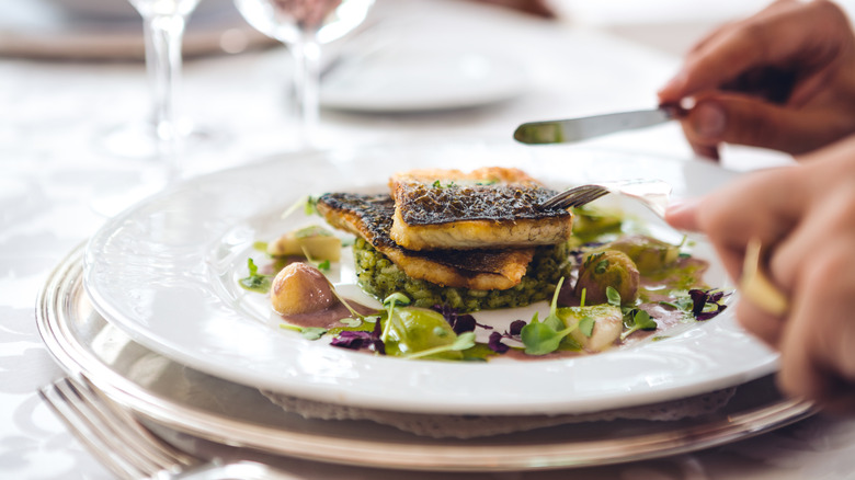 A plate of delicately grilled fish and microgreens.