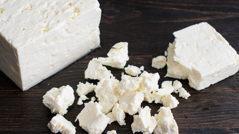 Block of feta cheese broken into crumbles