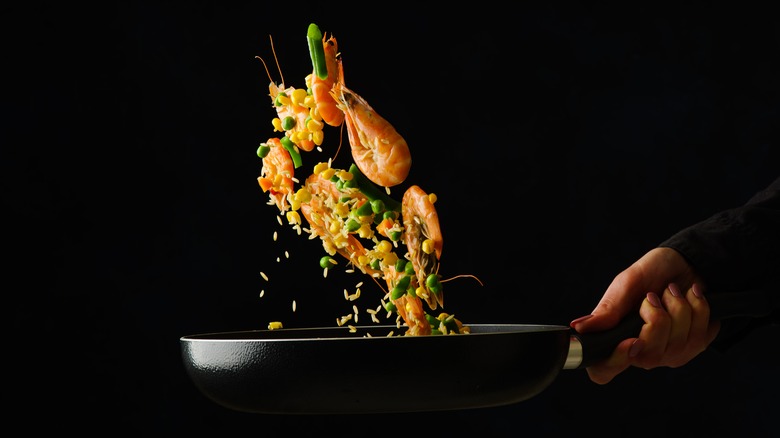 Fried rice tossed in pan