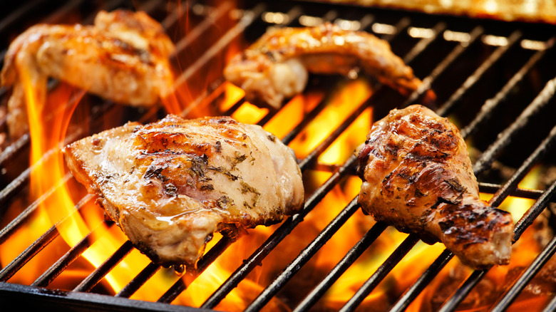 Chicken thigh and leg on a grill.