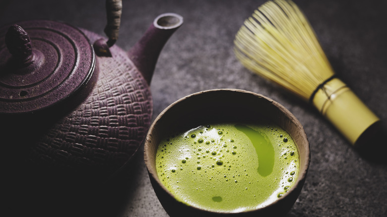 Cup of matcha and bamboo whisk