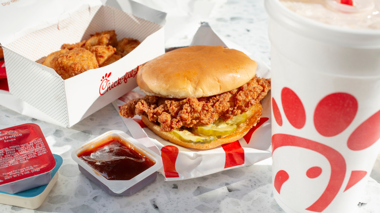 Chick-fil-A chicken sandwich, nuggets, sauce, and a drink