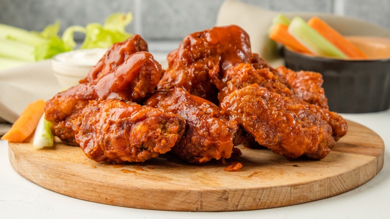 saucy buffalo wings on platter