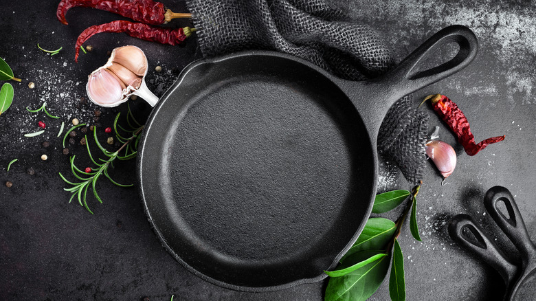 cast iron pan displayed alongside array of spices
