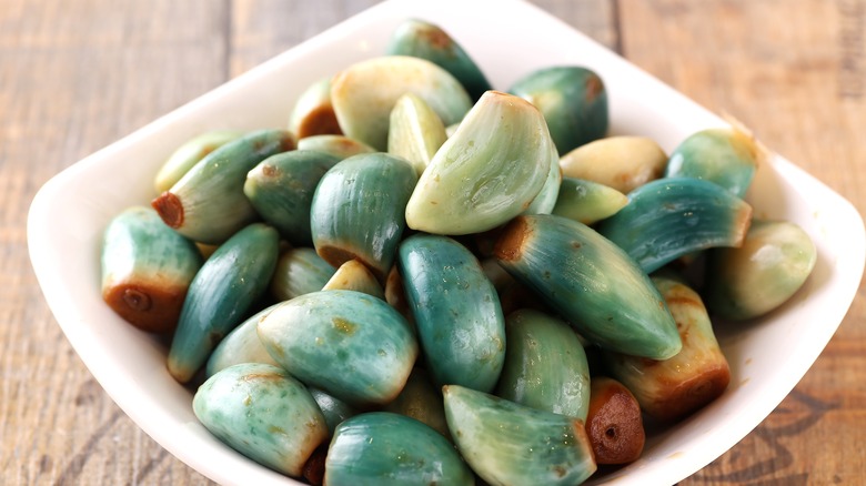 bowl of greenish garlic cloves