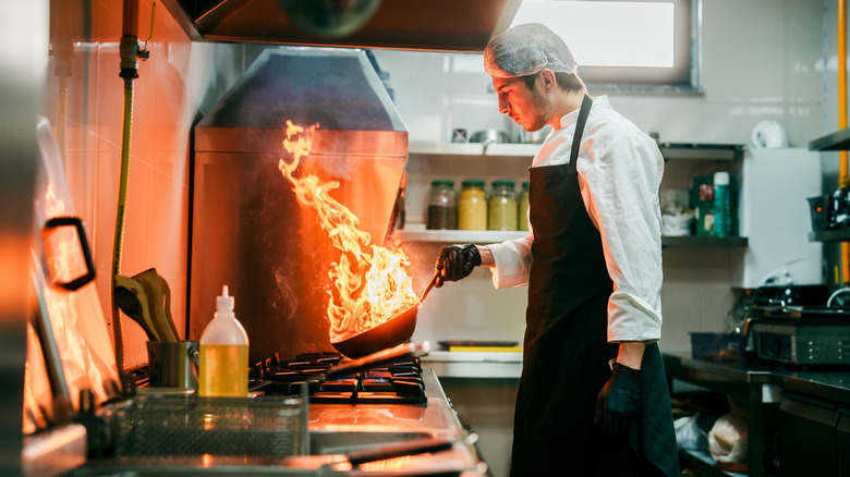 A chef using a wok.