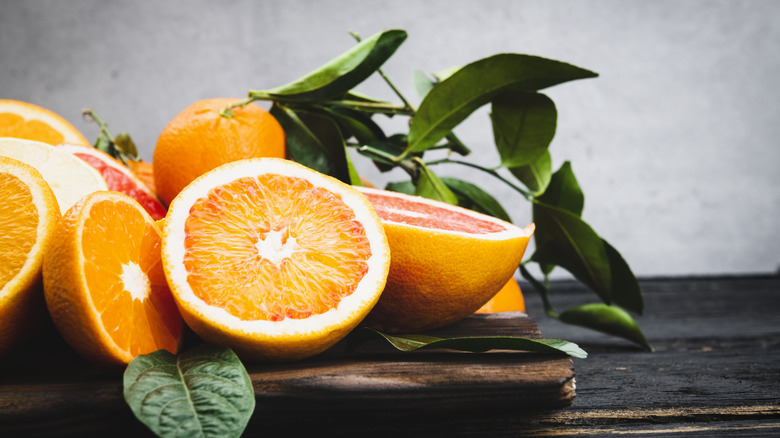 Cut oranges on wooden table