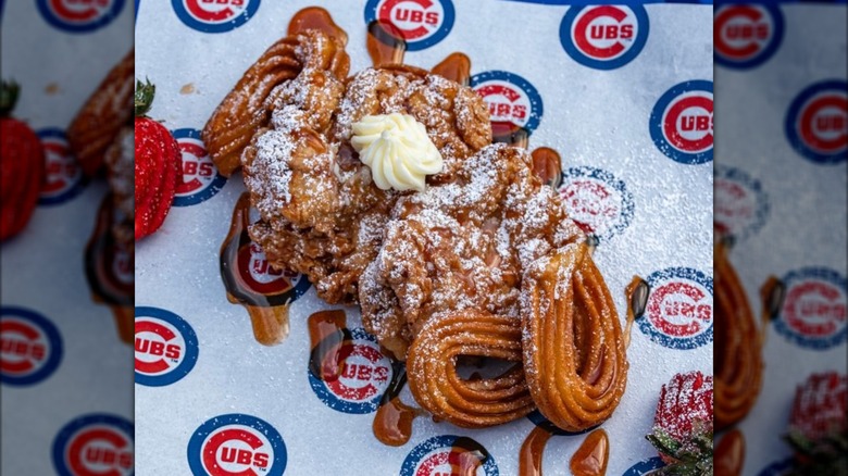 Plate of chicken and churros with powdered sugar
