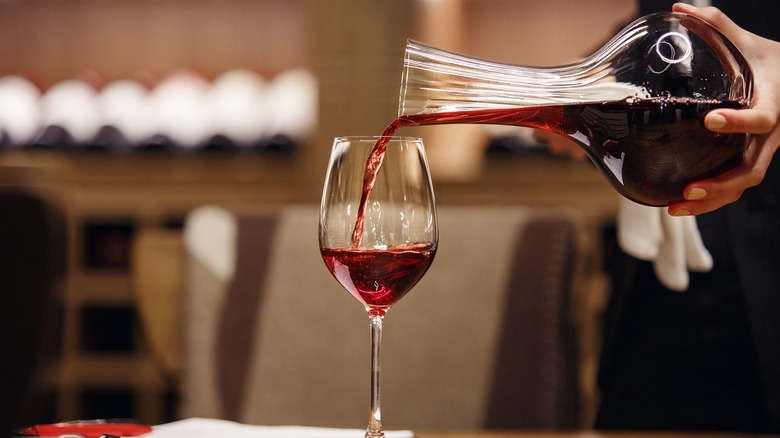 wine poured into glass from decanter