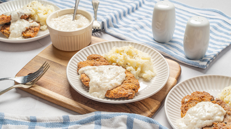 Plates of chicken-fried steak with gravy.