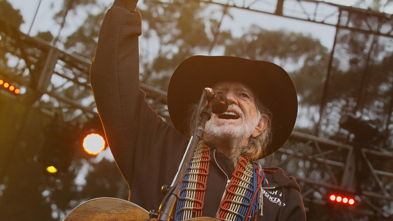 Willie Nelson performing on stage.