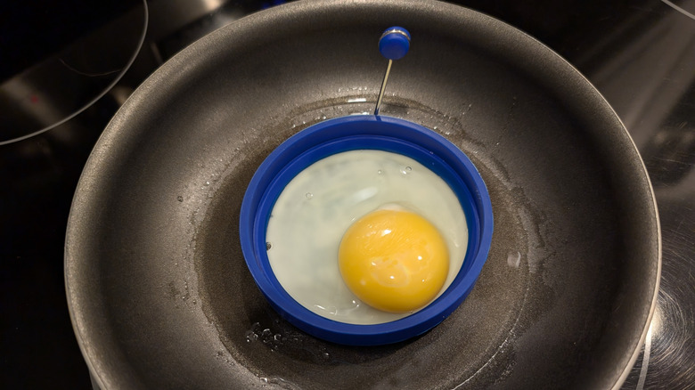 Egg cooking in a silicone ring.