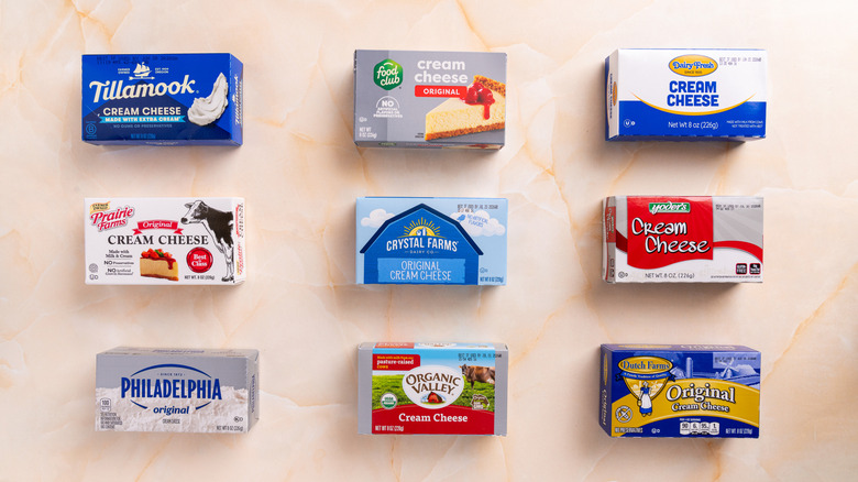 Several cream cheese varieties on a marbled surface.