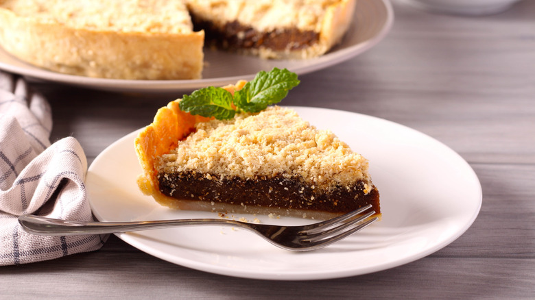 a slice of shoofly pie on a plate with fresh mint